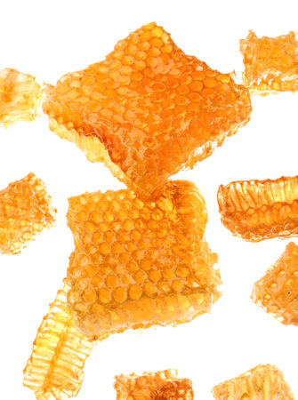 Flying sweet honeycombs on white background
