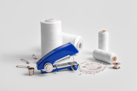 Manual sewing machine with different supplies on white backgroundの写真素材