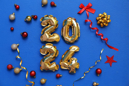 Figure 2024 made of balloons with Christmas decor on blue backgroundの写真素材