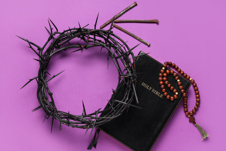 Crown of thorns with Bible, beads and nails on purple background. Good Friday conceptの写真素材