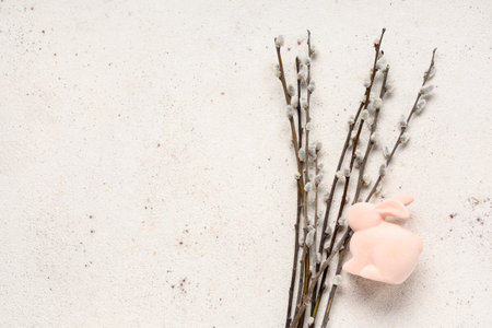 Pussy willow branches and toy bunny on white background. Easter celebrationの写真素材