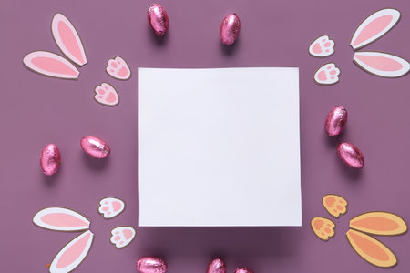 Blank card and Easter decor on purple backgroundの写真素材