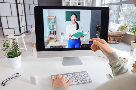 Male student studying with online teacher at home, closeup