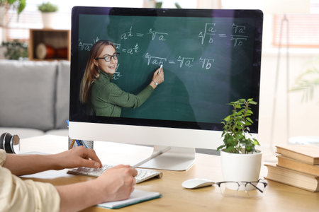 Male student studying Math with online teacher at home, closeupの写真素材