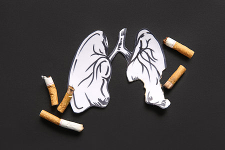 Paper lungs and cigarette butts on black background. Stop smoking concept.の写真素材