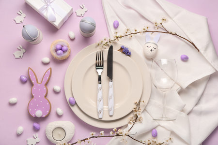 Beautiful table setting with Easter eggs and wine glass on lilac background