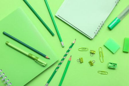 Different stationery on green background. Top viewの写真素材