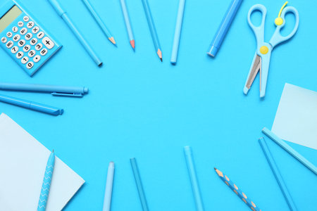 Frame made of different stationery on blue background. Top viewの写真素材