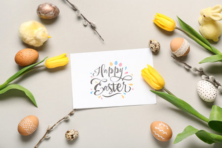 Greeting card with text HAPPY EASTER, painted eggs and tulips on gray background. Top view