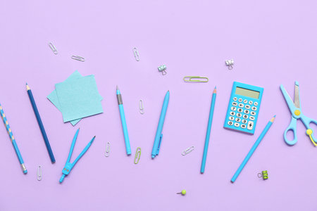 Pens, calculator and scissors on lilac background. Top viewの写真素材