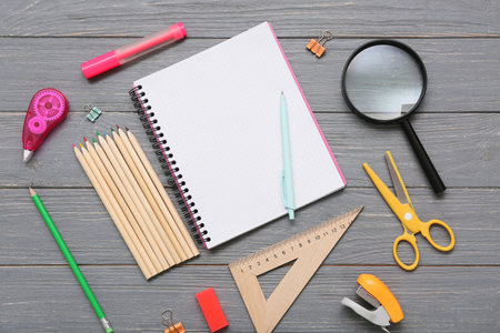 Different stationery on gray wooden background. Top viewの写真素材