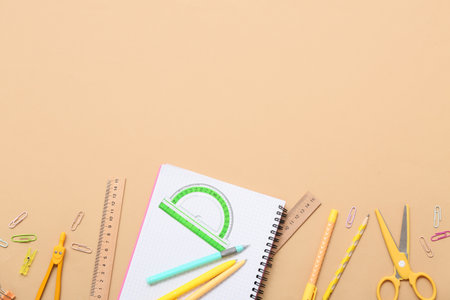 Notebook with protractor and pens on beige background. Top viewの写真素材