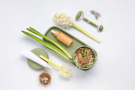Beautiful composition with spa accessories, flowers and Easter decor on light backgroundの写真素材