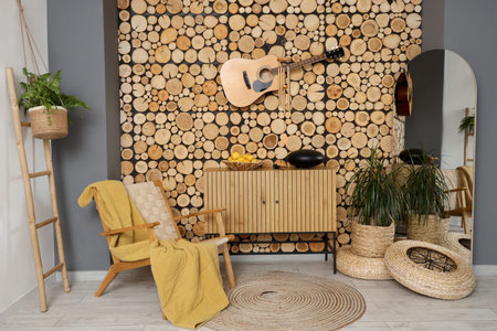 Interior of living room with wind chime, guitar and glucophone on drawers