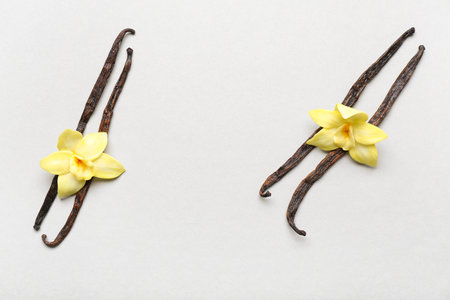 Aromatic vanilla sticks with flowers on light backgroundの写真素材