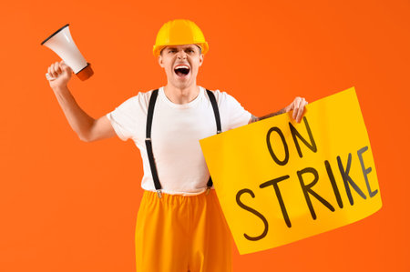 Protesting firefighter holding placard with text ON STRIKE and megaphone against orange background