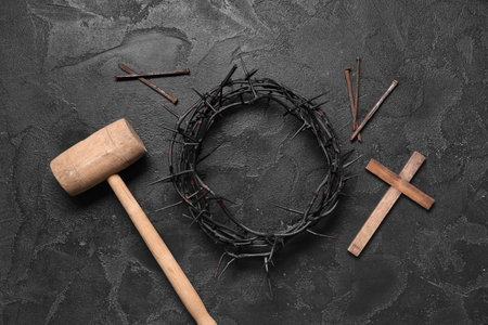 Crown of thorns with cross, wooden hammer and nails on black grunge background. Good Friday conceptの写真素材