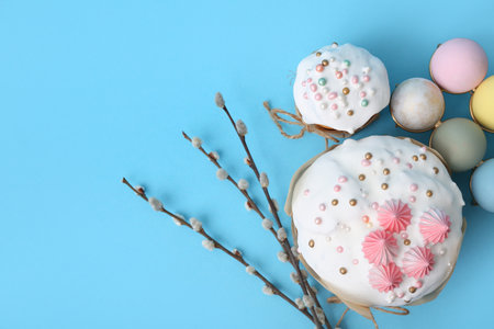 Easter cake, painted eggs and willow branches on blue backgroundの写真素材