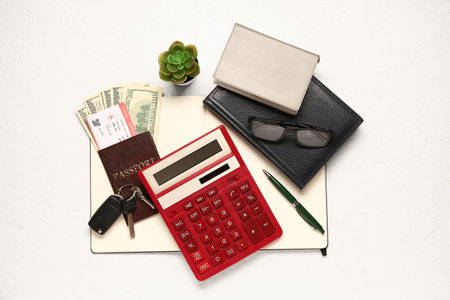 Calculator, notebooks, passport, ticket, car keys and money on light background