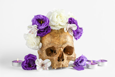 Human skull with beautiful flowers on white backgroundの写真素材