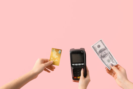 Women with credit card, payment terminal and dollar banknote on pink backgroundの写真素材