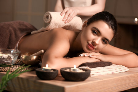 Beautiful woman receiving spa massage in salonの写真素材