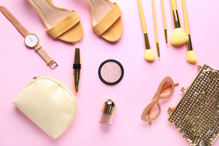 Composition with female accessories, shoes and cosmetics on pink backgroundの写真素材