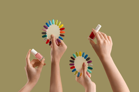 Women with nail tips and polishes on green backgroundの写真素材