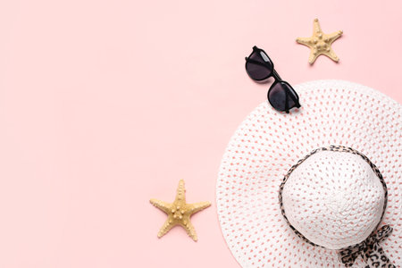Stylish hat, sunglasses and starfishes on color backgroundの写真素材