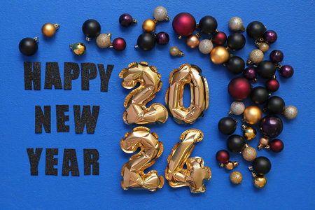 Figure made of balloons with Christmas balls and text HAPPY 2024 NEW YEAR on blue background