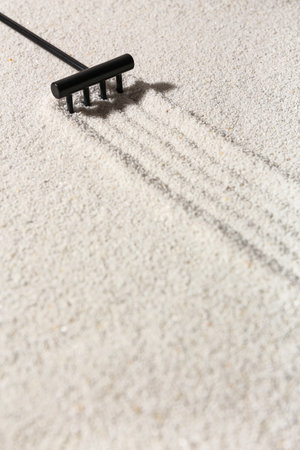 Rake making lines on sand in Japanese rock garden. Zen conceptの写真素材