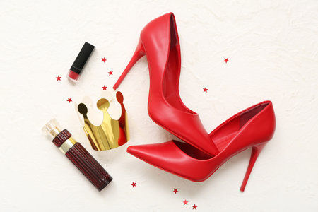 Paper crown with stylish high heels, lipstick and bottle of perfume on white background. Prom conceptの写真素材