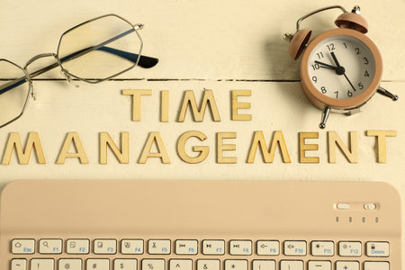 Text TIME MANAGEMENT, alarm clock and eyeglasses on white wooden background. Top view