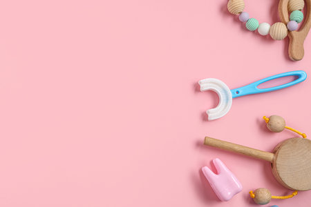 Children's toothbrush with toys on pink background