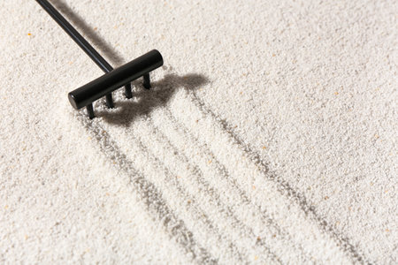 Rake making lines on sand in Japanese rock garden. Zen conceptの写真素材