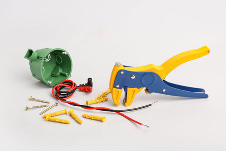 Set of different electrician's tools on light background
