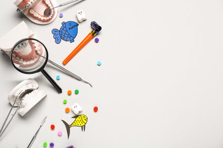 Composition with dentist's tools and decor for April Fools Day on light backgroundの写真素材