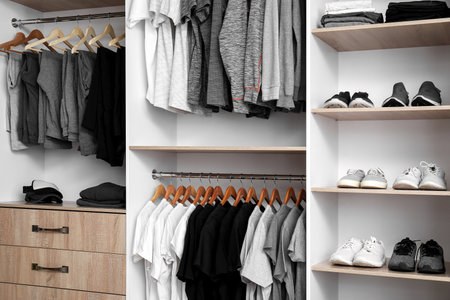 Rack with stylish male clothes and accessories in modern wardrobeの写真素材