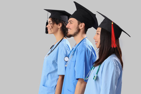 Proud medical graduate students standing in line on white backgroundの写真素材