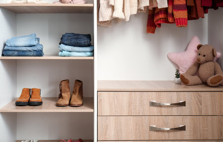 Rack with stylish autumn clothes in modern child's wardrobeの写真素材