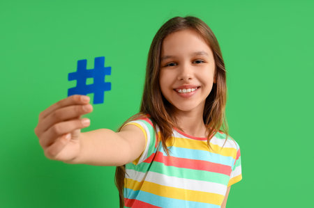 Cute teenage girl with hashtag on green background