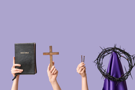 Female hands with Holy Bible, cross, nails and crown of thorns on lilac background. Good Friday conceptの写真素材