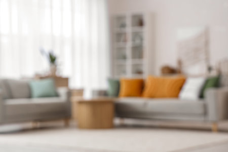 Blurred view of living room with 3D painting, sofas and tableの写真素材