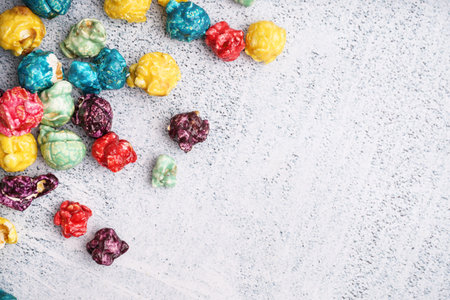 Sweet colorful popcorn on white background