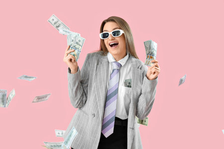 Funny young businesswoman with money on pink backgroundの写真素材