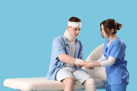 Injured young man after accident on couch with doctor against blue background