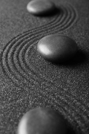 Spa stones on black sand with lines, closeup. Zen conceptの写真素材
