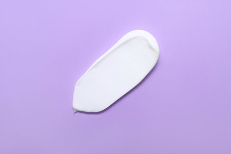 Sample of cosmetic cream on lilac backgroundの写真素材