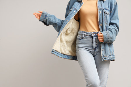 Young woman in stylish jeans clothes on white backgroundの写真素材