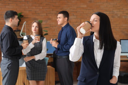 Young businesswoman having coffee break in officeの写真素材